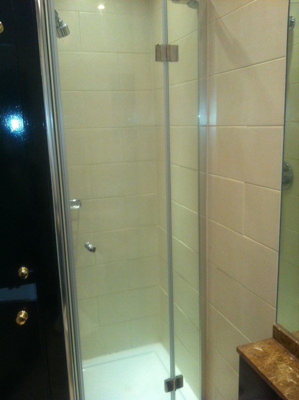 Frameless glass shower enclosure with chrome fittings in Wembley