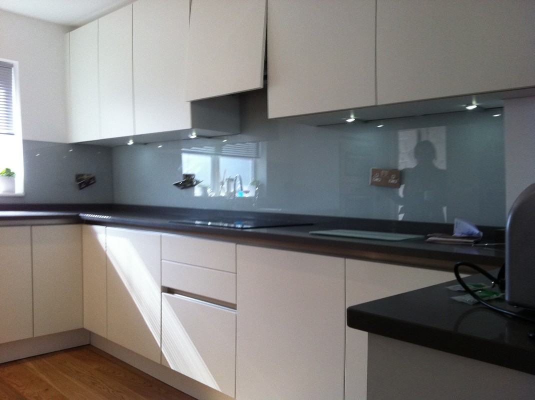 Grey glass kitchen splashback with LED lighting in Wembley